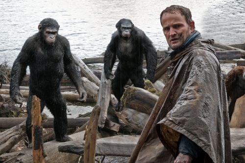 Malcolm (Jason Clarke, foreground) tries to make peace with Caesar (Andy Serkis, left), Koba (Toby Kebbell) and Maurice (Karin Konoval).